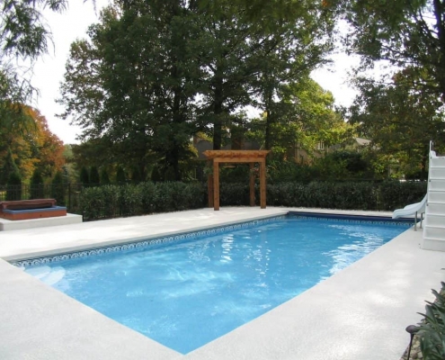 an in ground pool with a pergola