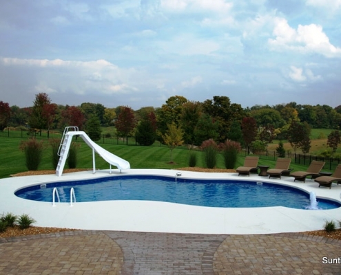 A high-quality free-form inground pool with slide and fountain