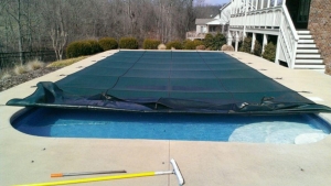 pool with a safety pool cover being removed